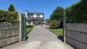 a driveway leading to a house with a fence at Apartamento en Casa Tía María in Bueu