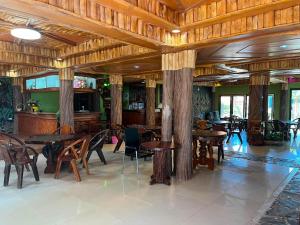 a restaurant with tables and chairs in a room at SWIMS! a Social Beach Resort in Haad Rin