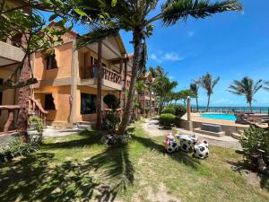 a resort with a pool and some palm trees at SWIMS! a Social Beach Resort in Haad Rin +34 photos