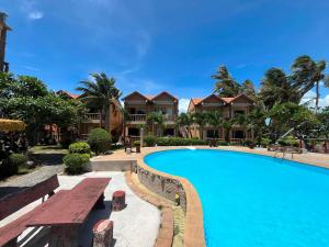 a resort with a swimming pool and houses at SWIMS! a Social Beach Resort in Haad Rin