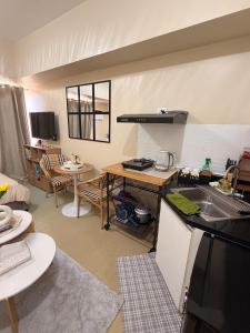 a kitchen and living room with a sink and a table at The Nook at Avida Towers 2 CDO in Cagayan de Oro +7 photos
