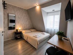 a small room with a bed and a window at Modern Living Apartment Hotel in Nuremberg +17 photos