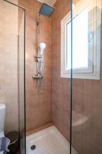 a shower in a bathroom with a glass shower backdoor at Corfu Glyfada Beach Apartment 91 in Glyfada