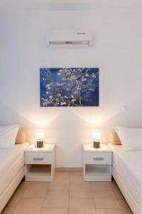 two beds in a room with two night stands at Corfu Glyfada Beach Apartment 91 in Glyfada