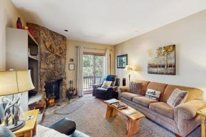 a living room with a couch and a fireplace at Cascade 347 in Durango Mountain Resort