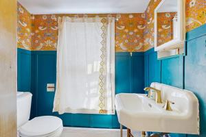 a blue bathroom with a sink and a toilet at The Hilltop - Main House in Waterbury +33 photos