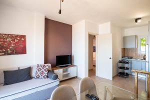 a living room with a couch and a tv at Corfu Glyfada Beach Apartment 91 in Glyfada +26 photos