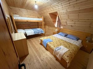 a bedroom with two beds in a log cabin at Te Oli Theth in Theth +38 photos