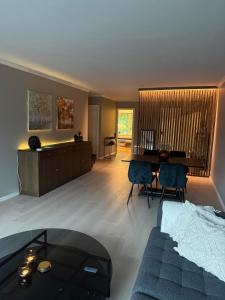 a living room with a couch and a table at Spacious apartment with 3 Bedrooms & balcony in Voss in Vossevangen