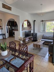 a living room with a couch and a table at Aegean Balcony in Tinos