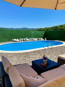 a backyard with a swimming pool and a patio furniture at Vila Edi Tuzla in Tuzla