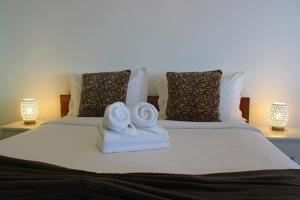 two towels on a bed with two pillows at The Wave House - Seaside Haven in Jardim do Mar