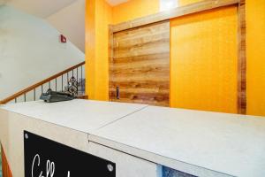 a kitchen with a counter with a wooden door at Super Collection O Sixmile Guwahati Formerly Hotel Gangotri in Guwahati