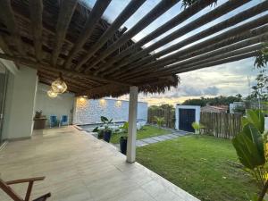 a wooden pergola on a patio with a yard at Casa Rio - Santo Amaro in Santo Amaro