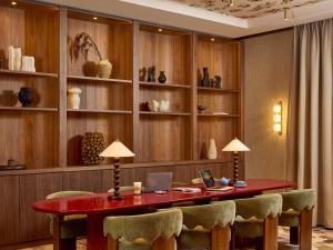 a room with a desk with a laptop on it at Grand Hôtel Roi René Aix - MGallery Collection in Aix-en-Provence
