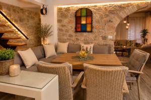 a living room with a table and chairs at Villa Bilja Historic Stone Castle in Trebinje