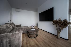 a living room with a couch and a table at Sodyba Biruta in Tautrimai +11 photos