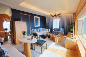 a living room with a couch and a table and chairs at The Park New Delhi in New Delhi