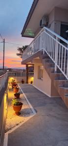 a house with stairs and plants inront of it at Imeros Summer Home in Ímeros