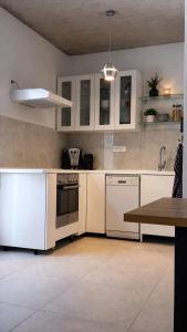 a kitchen with white appliances and a table in it at Apartment Bunja No3 in Drage