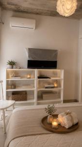 a bedroom with a bed with candles on a table at Apartment Bunja No3 in Drage
