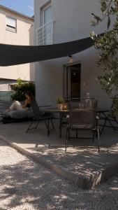 a woman laying on a patio with a table and chairs at Apartment Bunja No3 in Drage