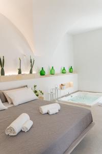 a bedroom with a large bed and a bath tub at "Corte Tedesco" - Apulian Luxury Suites in Brindisi +77 photos