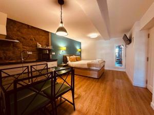 a bedroom with a bed and a couch in a room at Casa Jardim in Porto