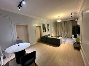 a living room with a table and a couch at Luimora Stays in Bamgbose