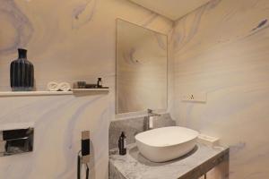 a white bathroom with a sink and a mirror at The Park New Delhi in New Delhi +77 photos