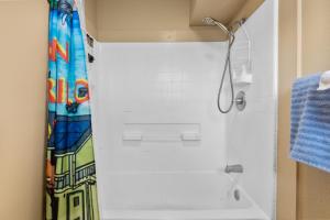 a shower in a bathroom with a shower curtain at Garden Balcony • Walk to Beach + Kitchen in Hilo