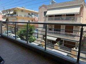 a cage with animals in it on a balcony at Otium Apartment in Nea Peramos