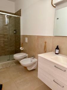a bathroom with a toilet and a sink and a shower at Violahouse in Bari +19 photos