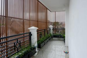 a hallway of a building with a fence at Kinari Sharia Living in Kediri