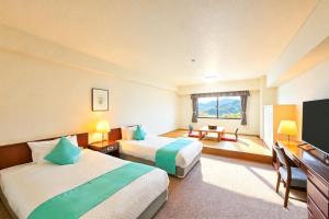 a hotel room with two beds and a television at Livemax Resort Hachimantai Forest in Hachimantai