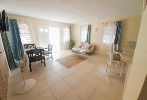 a living room with a couch and a table at Ocean Bliss Apartments in Christ Church
