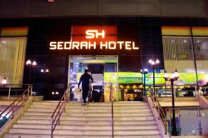 a man is walking into a seventh hotel at The Apartments By Sedrah in Irbid