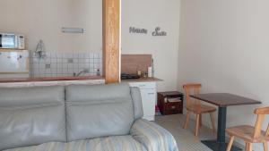 a living room with a couch and a table at Le Platane in Brioux-sur-Boutonne