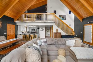 a living room with a couch and a staircase at Spacious Flagstaff A-Frame Casita Getaway in Flagstaff