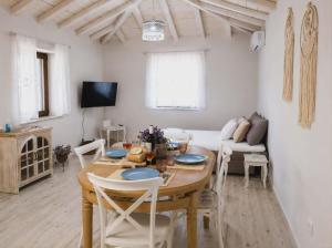 a living room with a table and a couch at Paliokaliva Home in Roussopoúlion