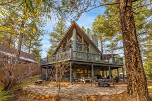 a house with a wrap around porch with a deck at Spacious Flagstaff A-Frame Casita Getaway in Flagstaff