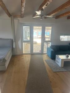 a living room with a couch and a table at Apartmani Adi Tkon in Tkon