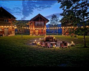 a fire pit in front of a log cabin at night at BUAMA Kammer in Abtenau