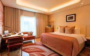 a hotel room with a bed and a desk at The Park New Delhi in New Delhi