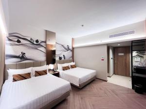 a hotel room with two beds and a room with at Grand Zuri Malioboro in Yogyakarta +28 photos