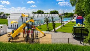 a playground with a slide and a water park at DESTINO wakacyjne domki-dwa podgrzewane baseny-drink bar in Mielno