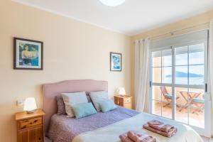 a bedroom with a bed and a balcony at Blue Emi Altea Hills in Altea la Vieja +29 photos