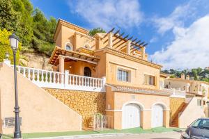 a house on a hill with a car parked in front at Blue Emi Altea Hills in Altea la Vieja