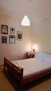 a bedroom with a large bed with a light at Grapes and Roses in Igoumenitsa
