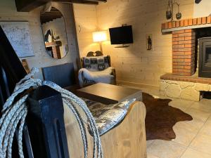 a living room with a table and a fireplace at Gîte des vergnioux in Ayat-sur-Sioule